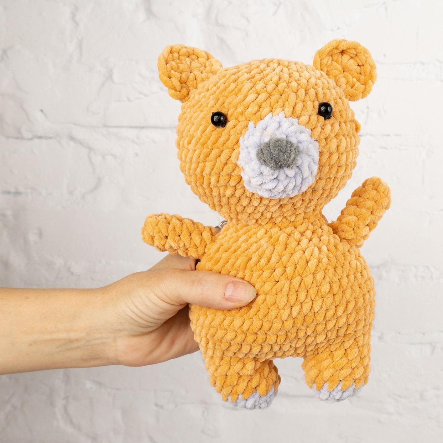 a teddy bear made out of yarn on a table