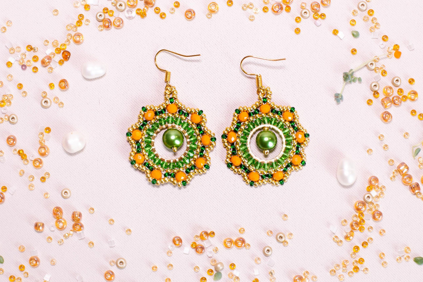 a pair of green and yellow beaded earrings