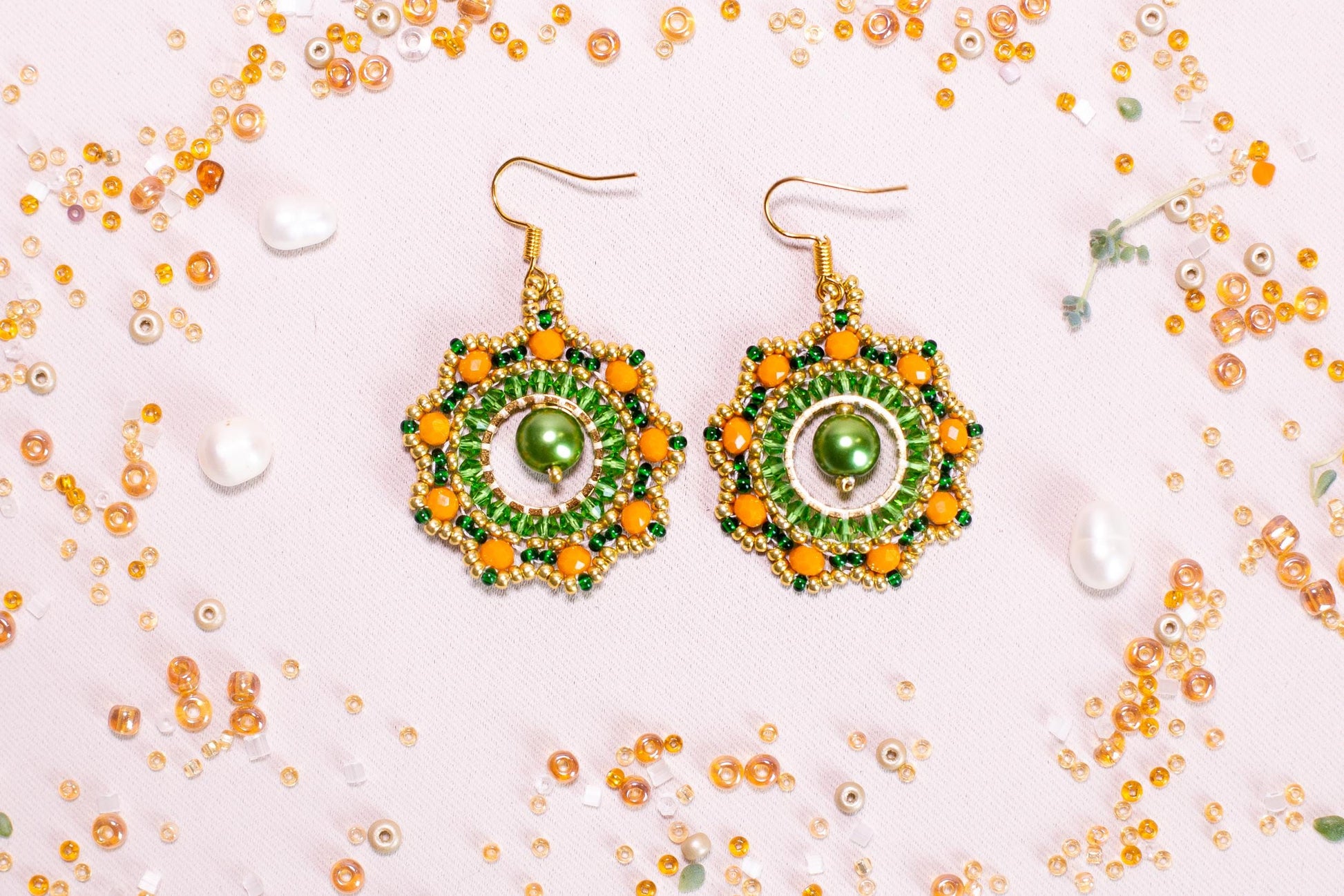 a pair of green and yellow beaded earrings