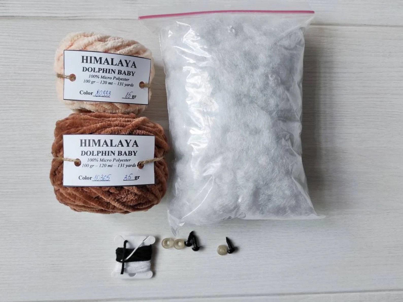 a bag of yarn next to a bag of buttons