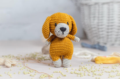 a crocheted dog is standing on a table