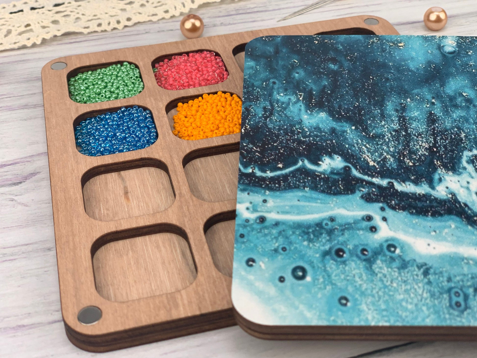 a wooden box filled with lots of different colored beads