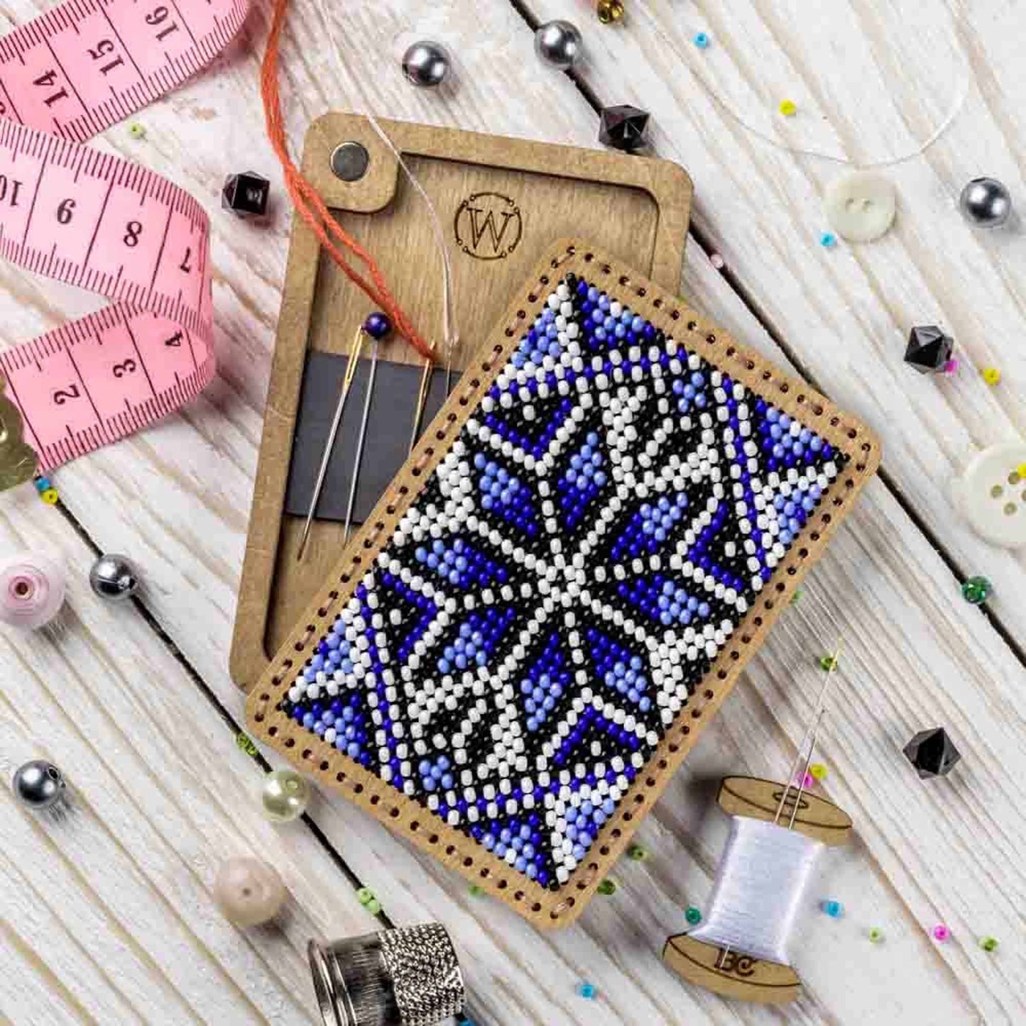a cross stitch ornament next to a pair of scissors
