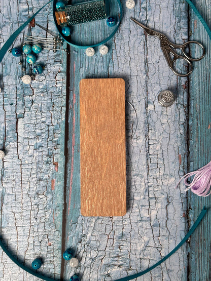 a wooden plaque surrounded by other items on a table