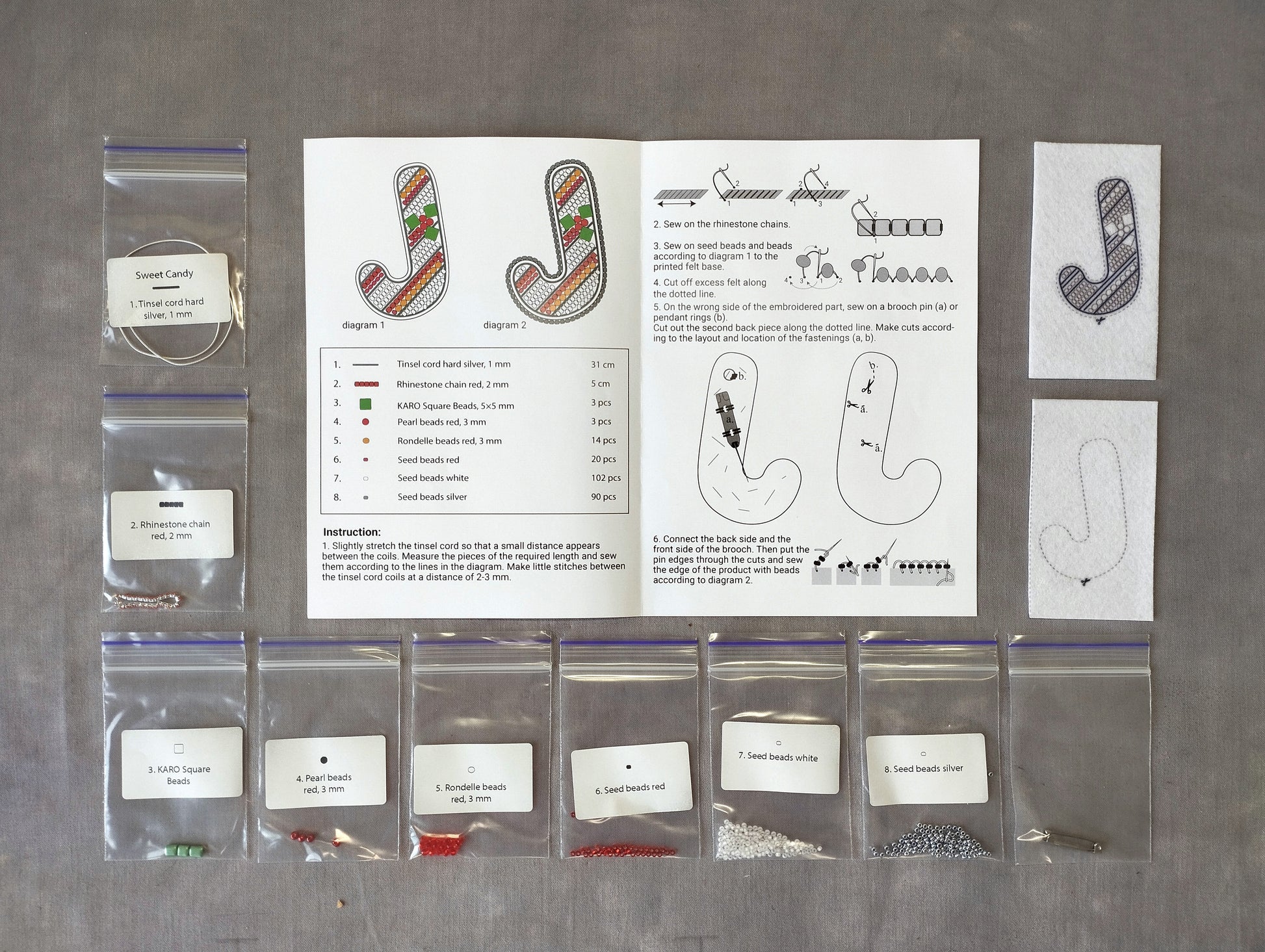 various craft supplies and materials, including bags of beads, string, and other embellishments, arranged on a table.