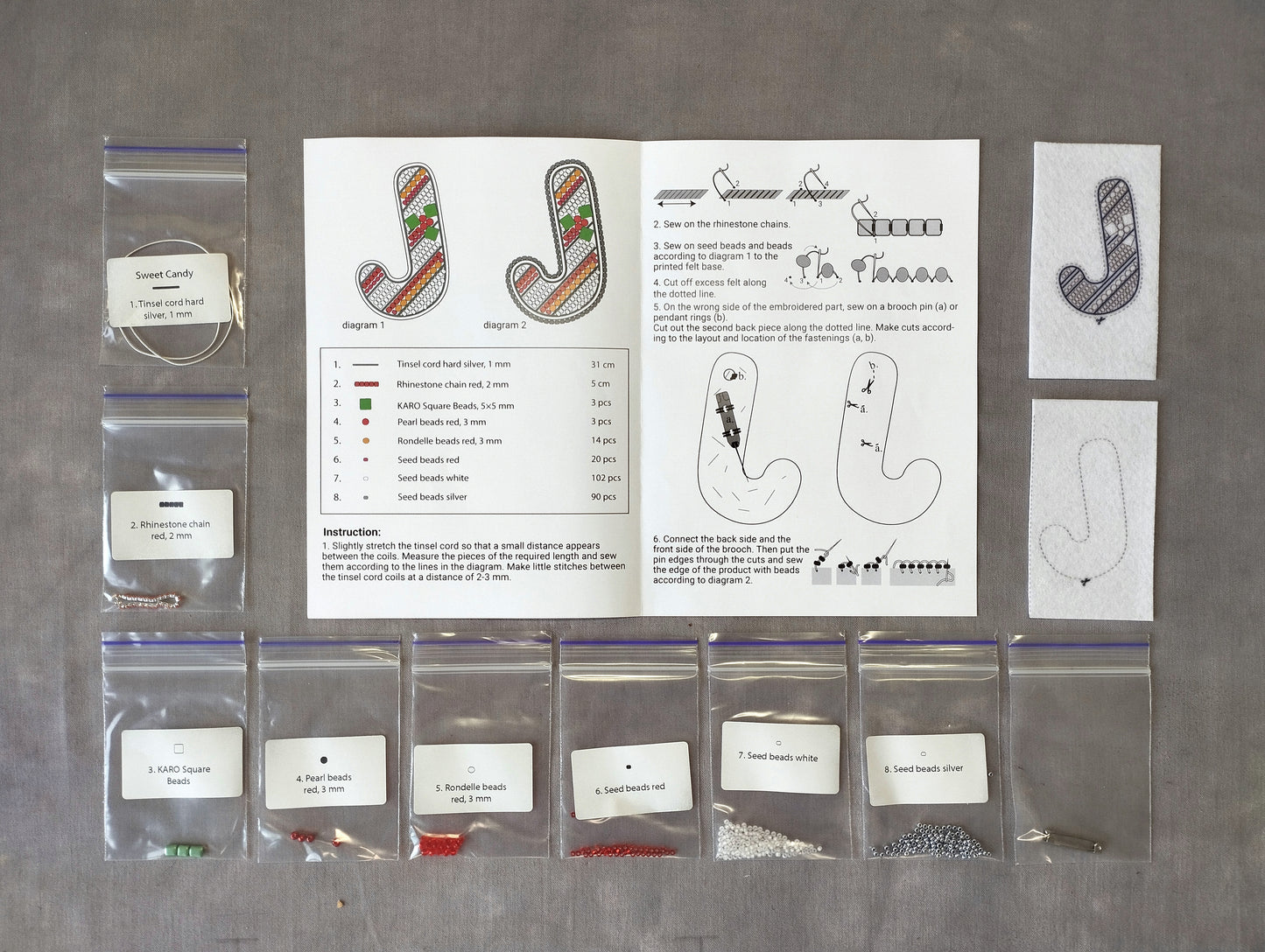 various craft supplies and materials, including bags of beads, string, and other embellishments, arranged on a table.