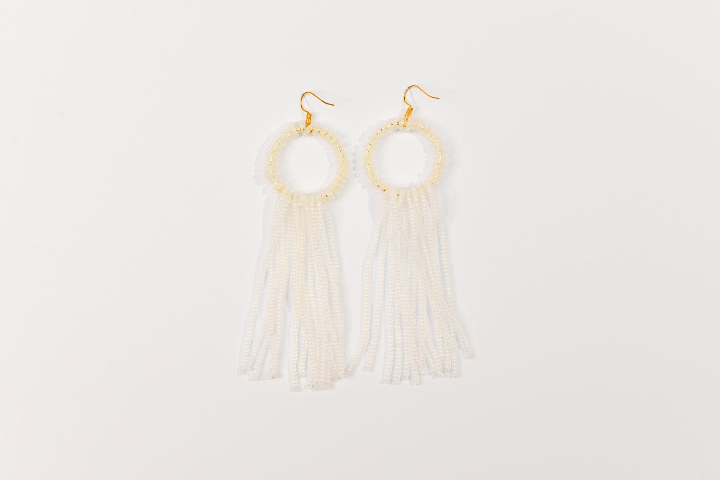 a pair of earrings with tassels hanging from them