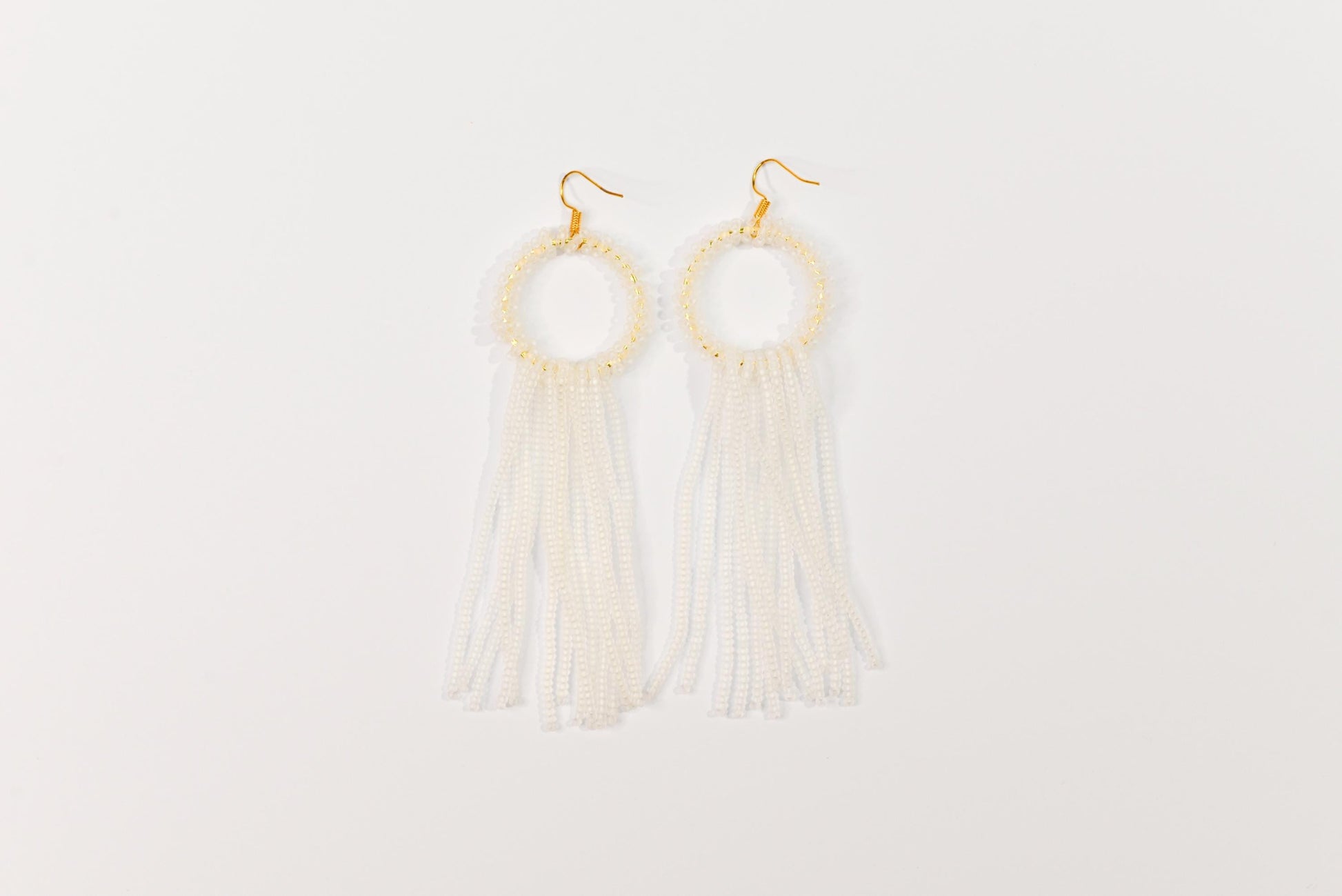 a pair of earrings with tassels hanging from them