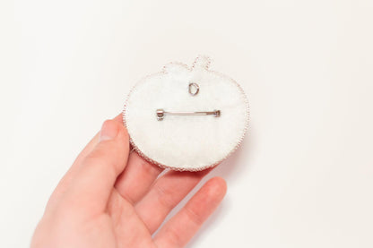 a person holding a small white object in their hand