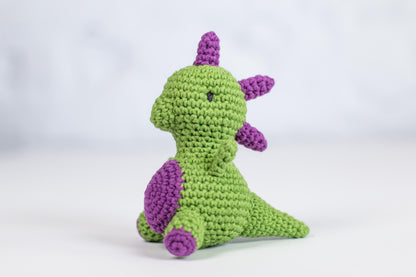 a crocheted green and purple stuffed animal