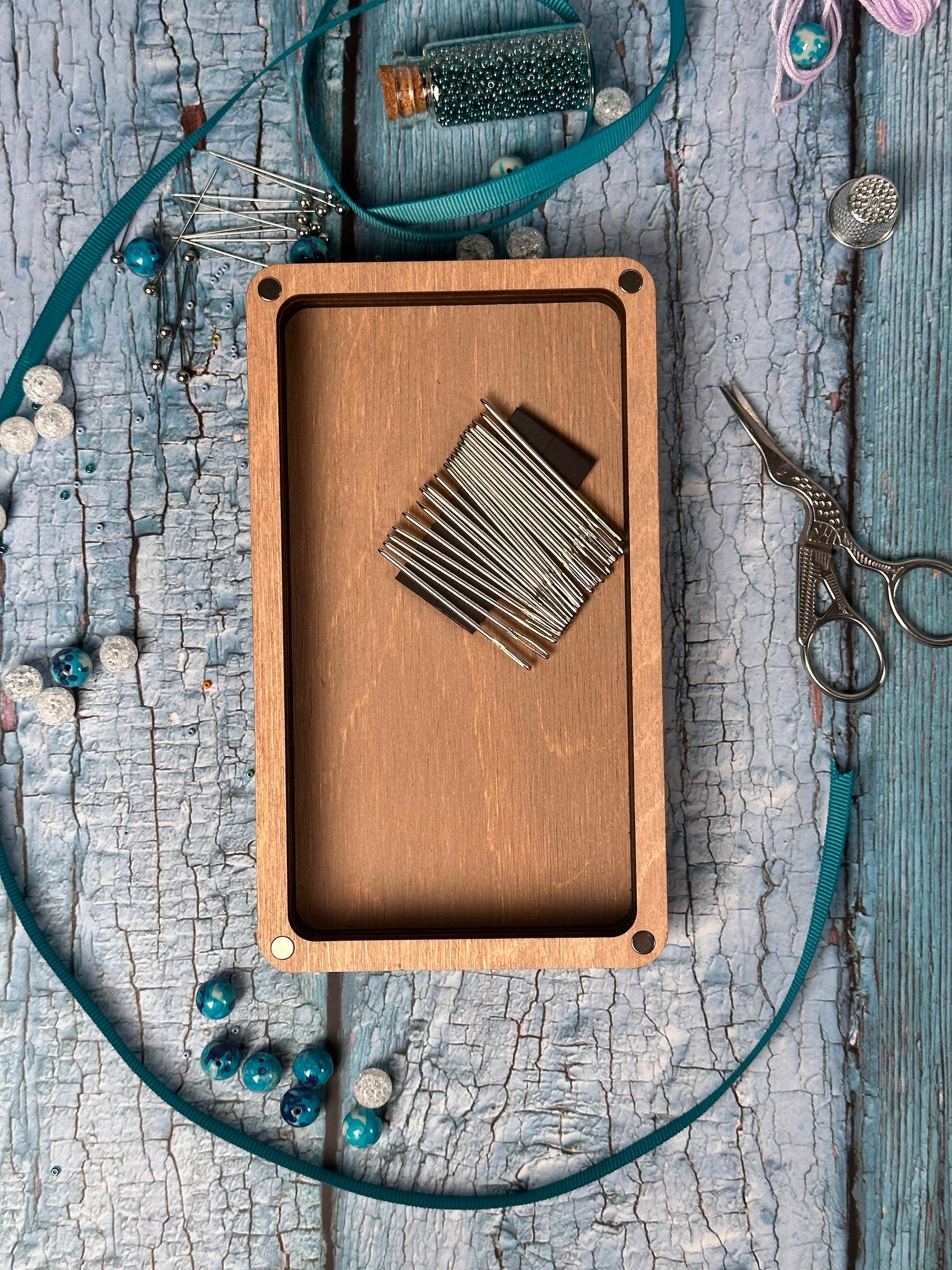 a wooden cutting board with a bunch of scissors on top of it