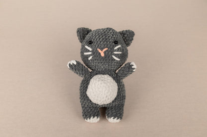 a crocheted black and white kitty cat