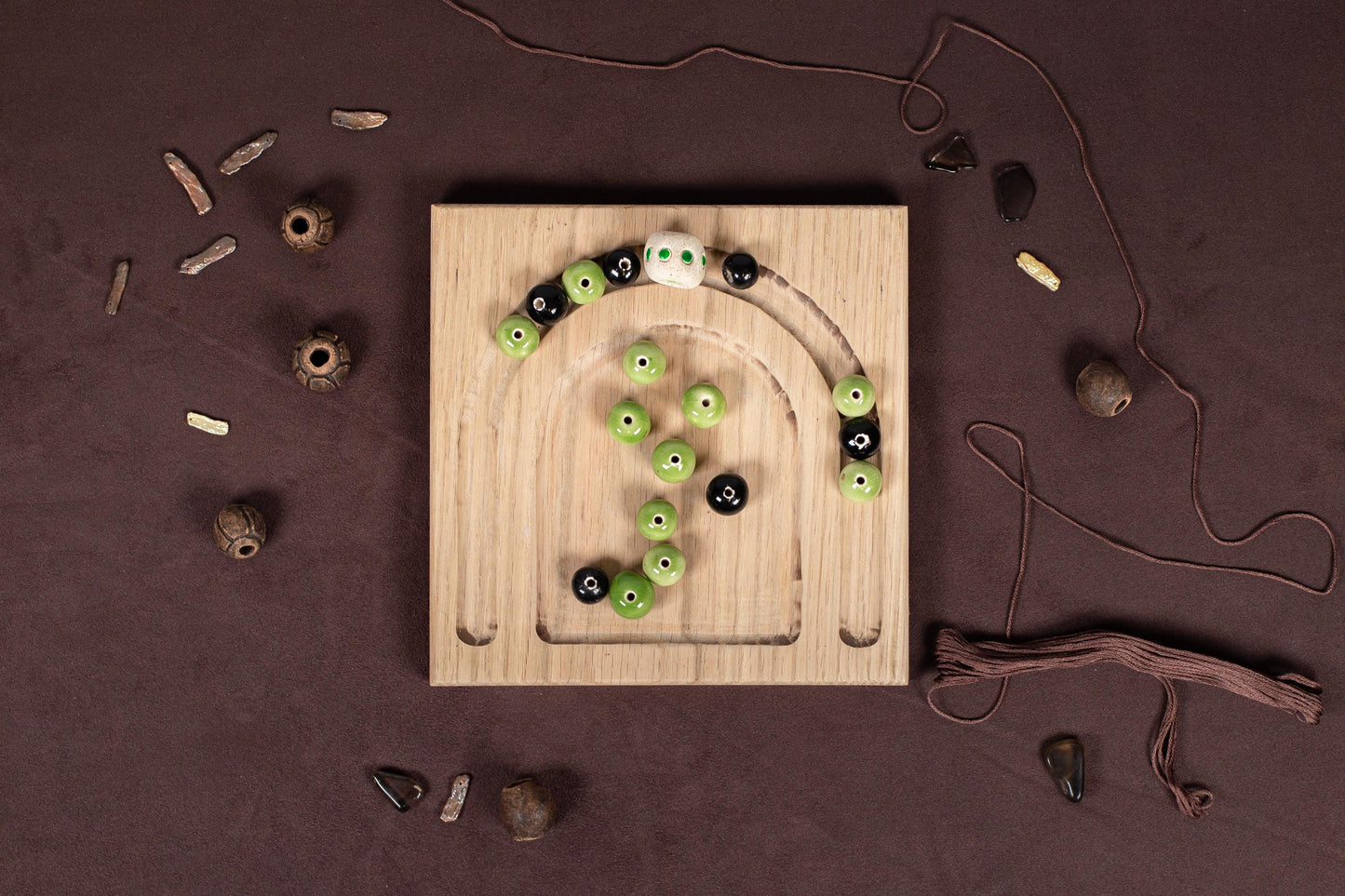 a wooden board with green and black buttons on it