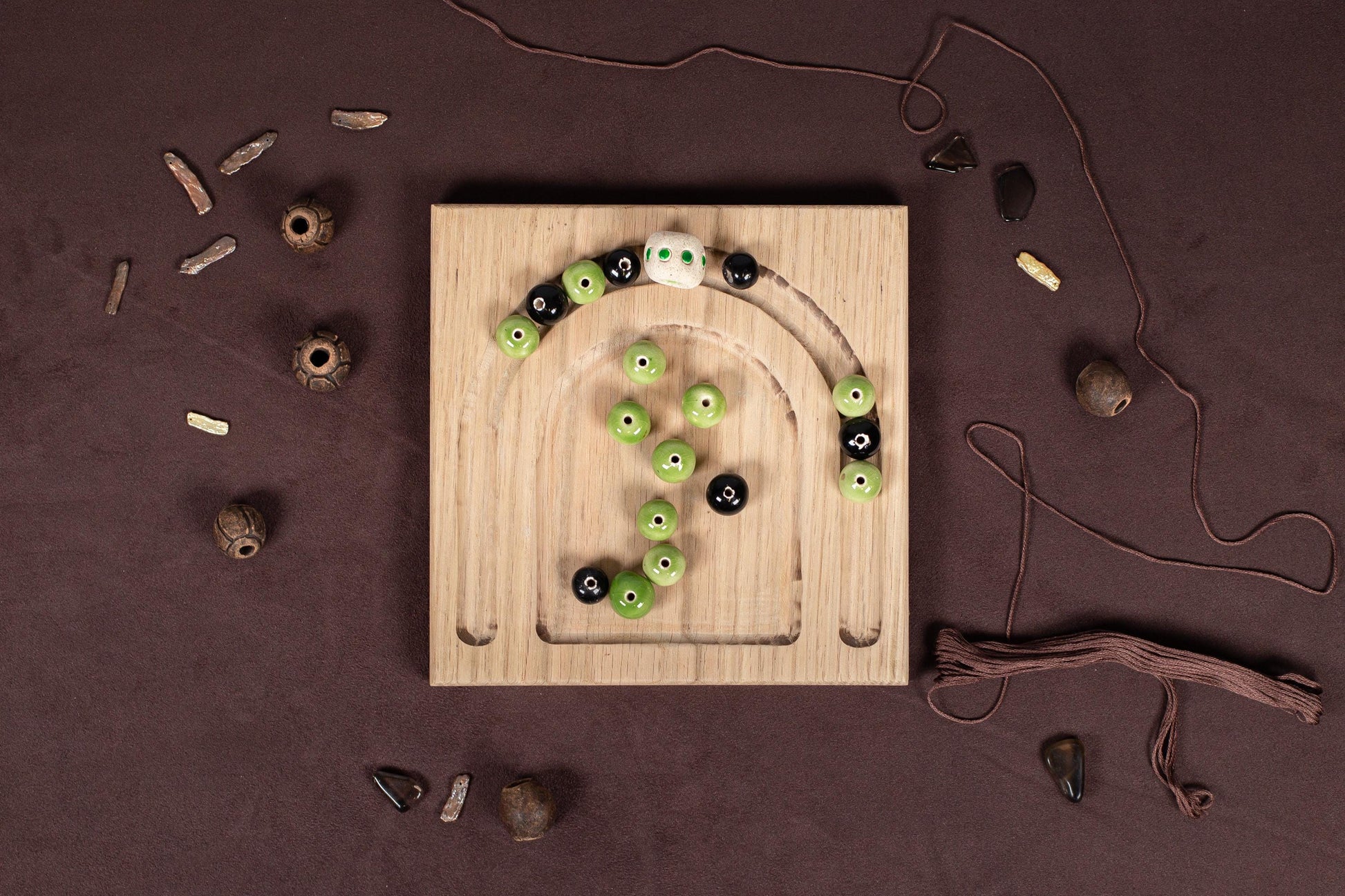 a wooden board with green and black buttons on it