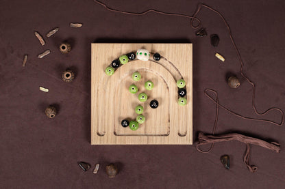 a wooden board with green and black buttons on it