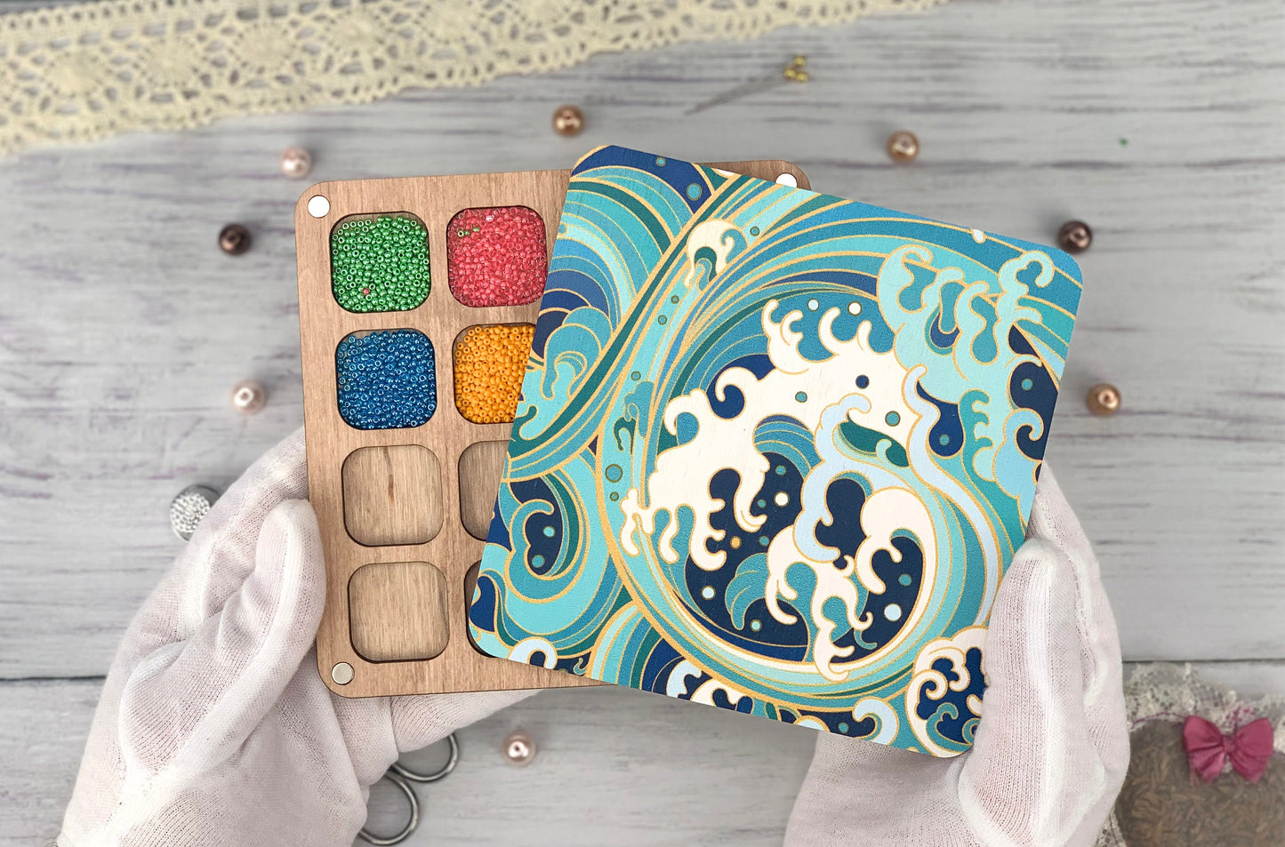 a person holding a wooden box with a painting on it