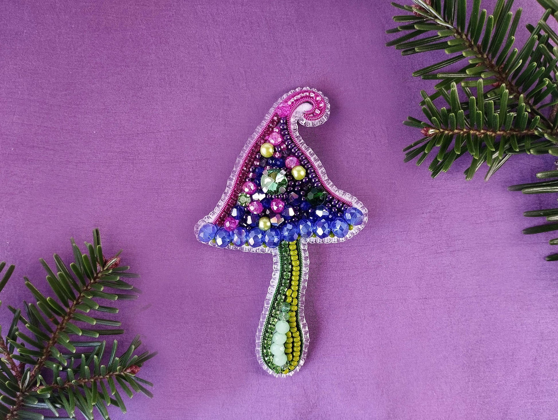 a christmas tree ornament on a purple background