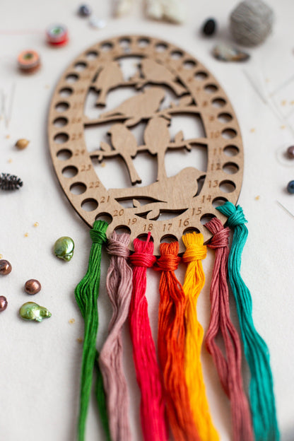 a wooden decoration with tassels on a table