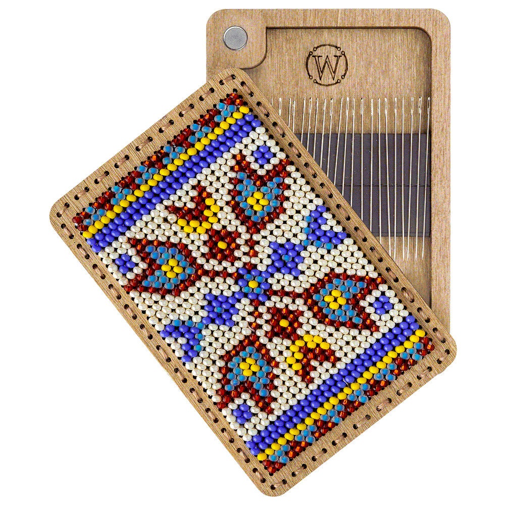 a wooden tray with a needle and a needle holder