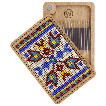 a wooden tray with a needle and a needle holder