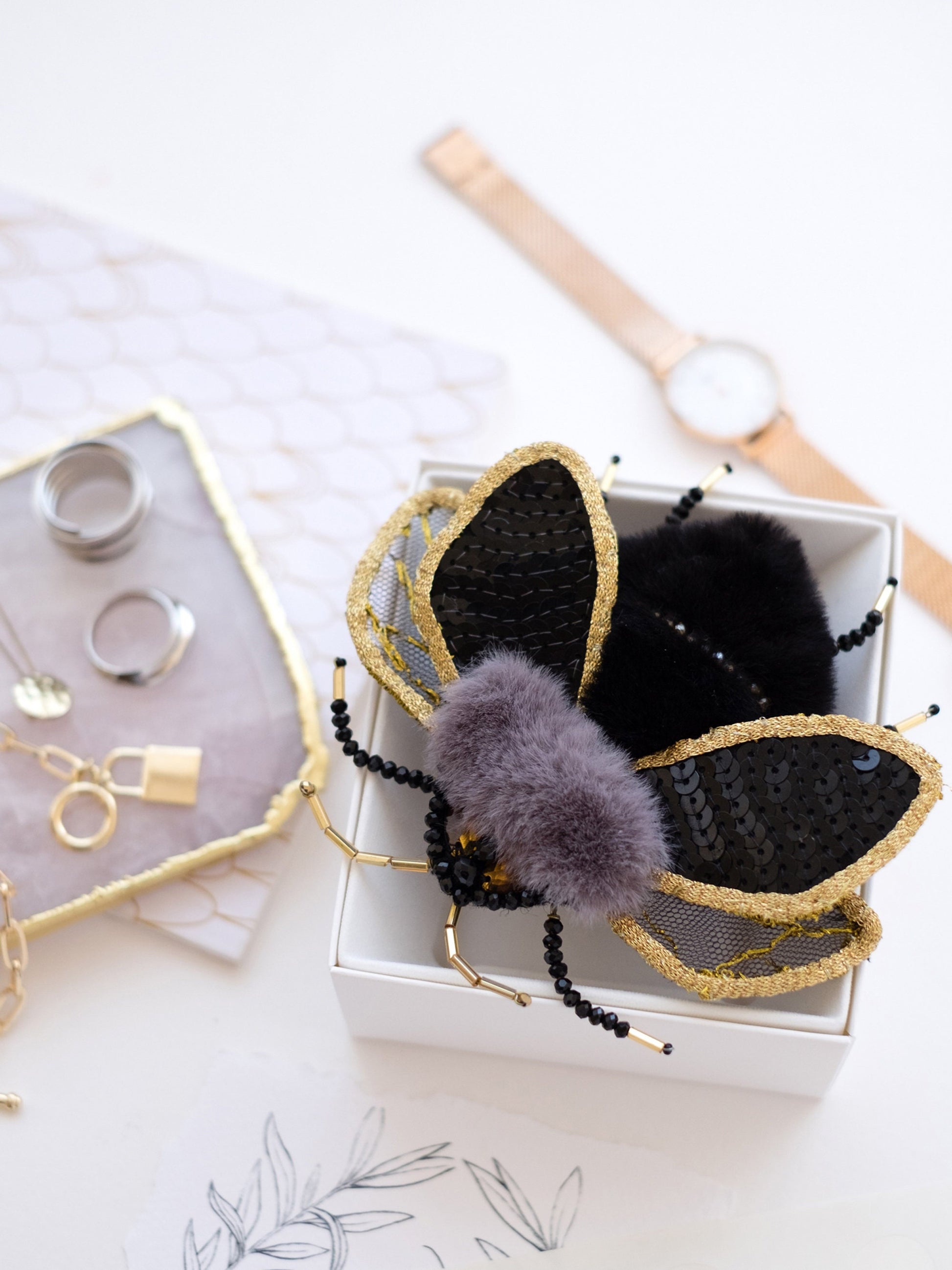 a white box with some black and gold items in it
