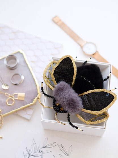 a white box with some black and gold items in it
