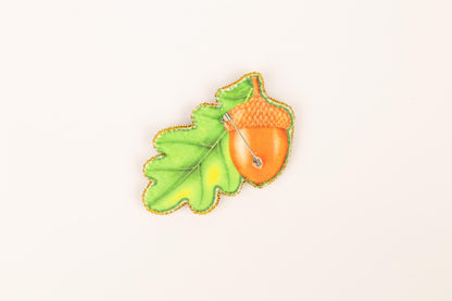 a picture of a leaf and a acorn on a white background