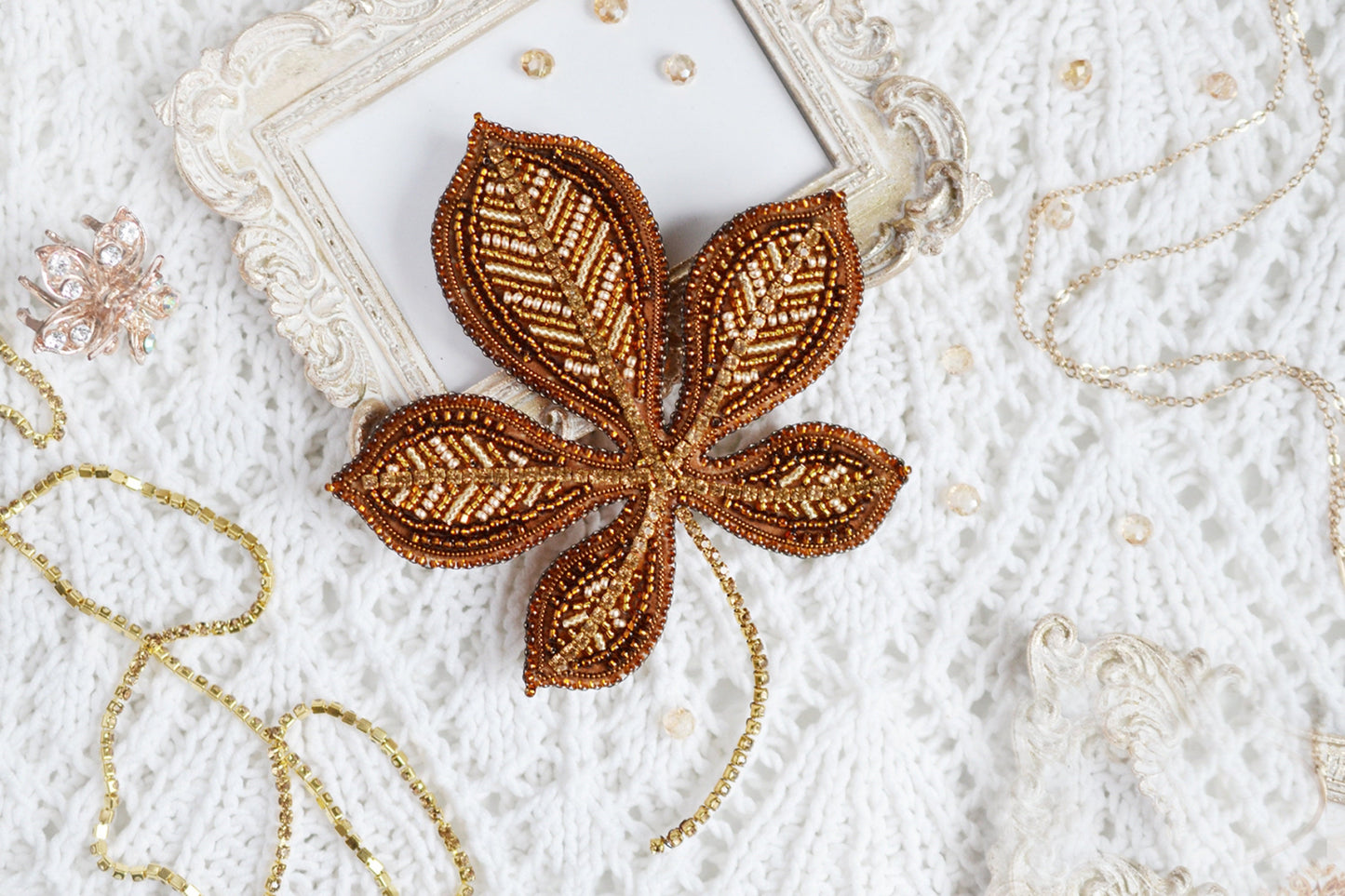 a picture frame with a beaded flower on it