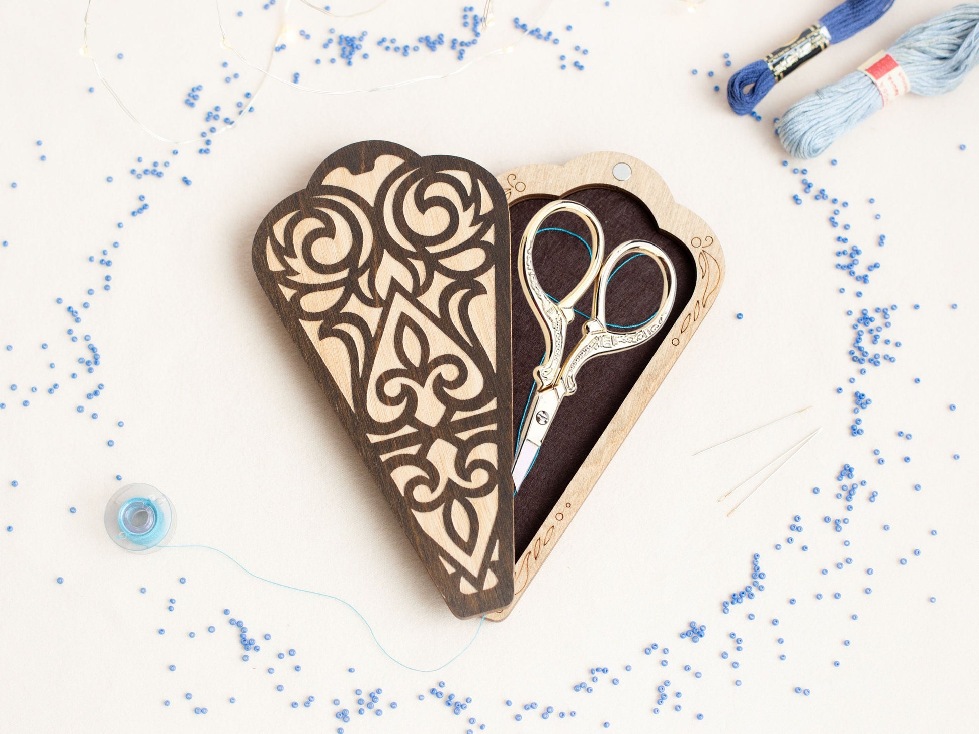 a pair of scissors sitting inside of a heart shaped box