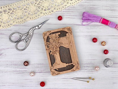a wooden block with a picture of a woman on it next to a pair of