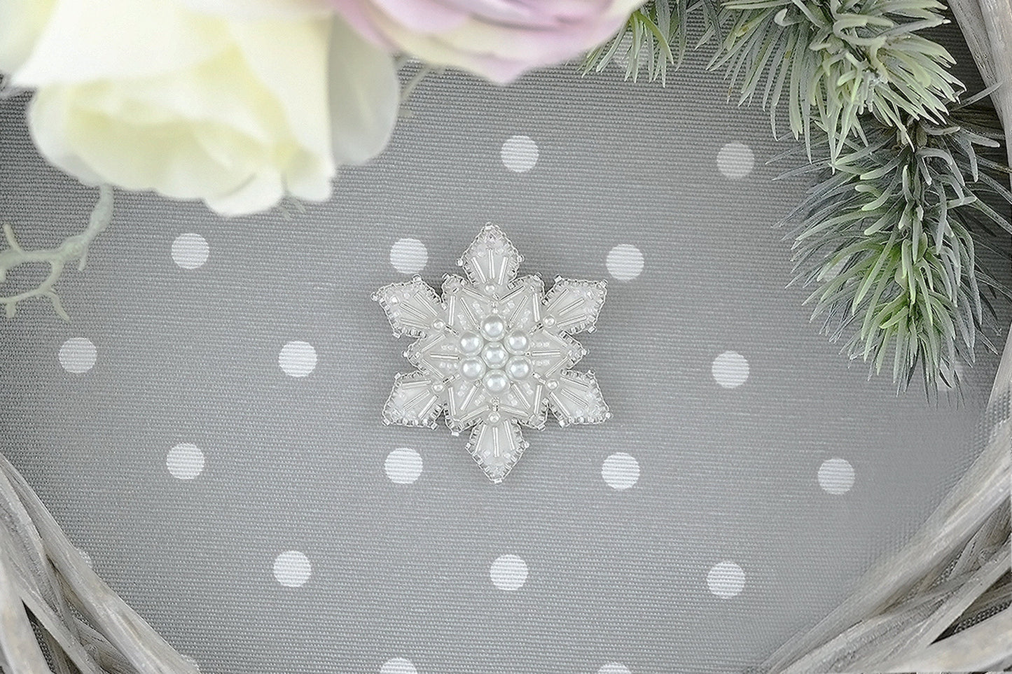 a snowflake brooch sitting on top of a table