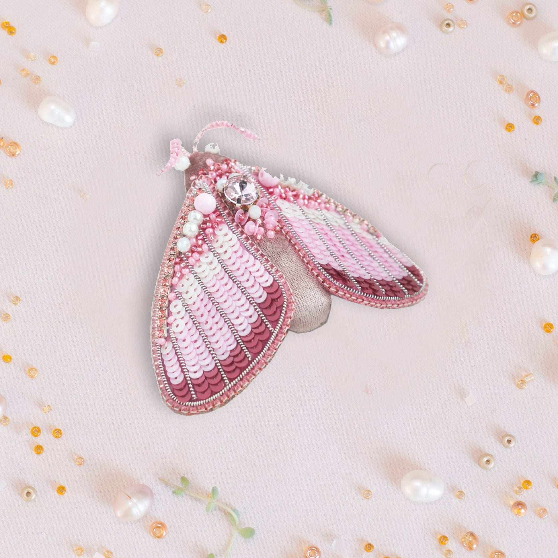 a close up of a pink purse with pearls