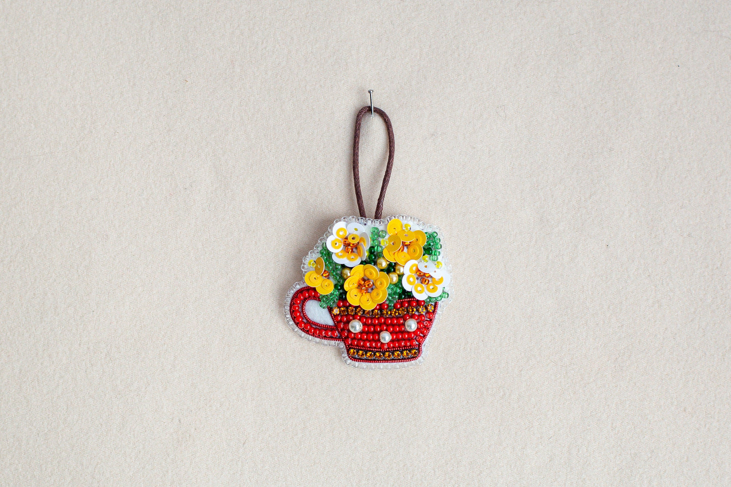 a picture of a flower pot ornament hanging on a wall