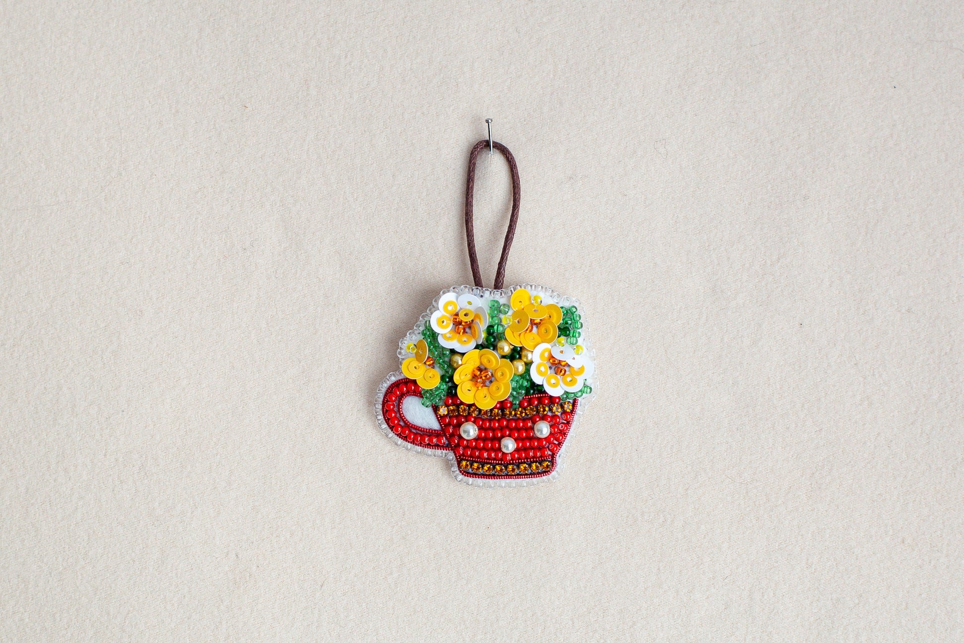 a picture of a flower pot ornament hanging on a wall