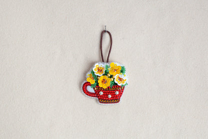 a picture of a flower pot ornament hanging on a wall