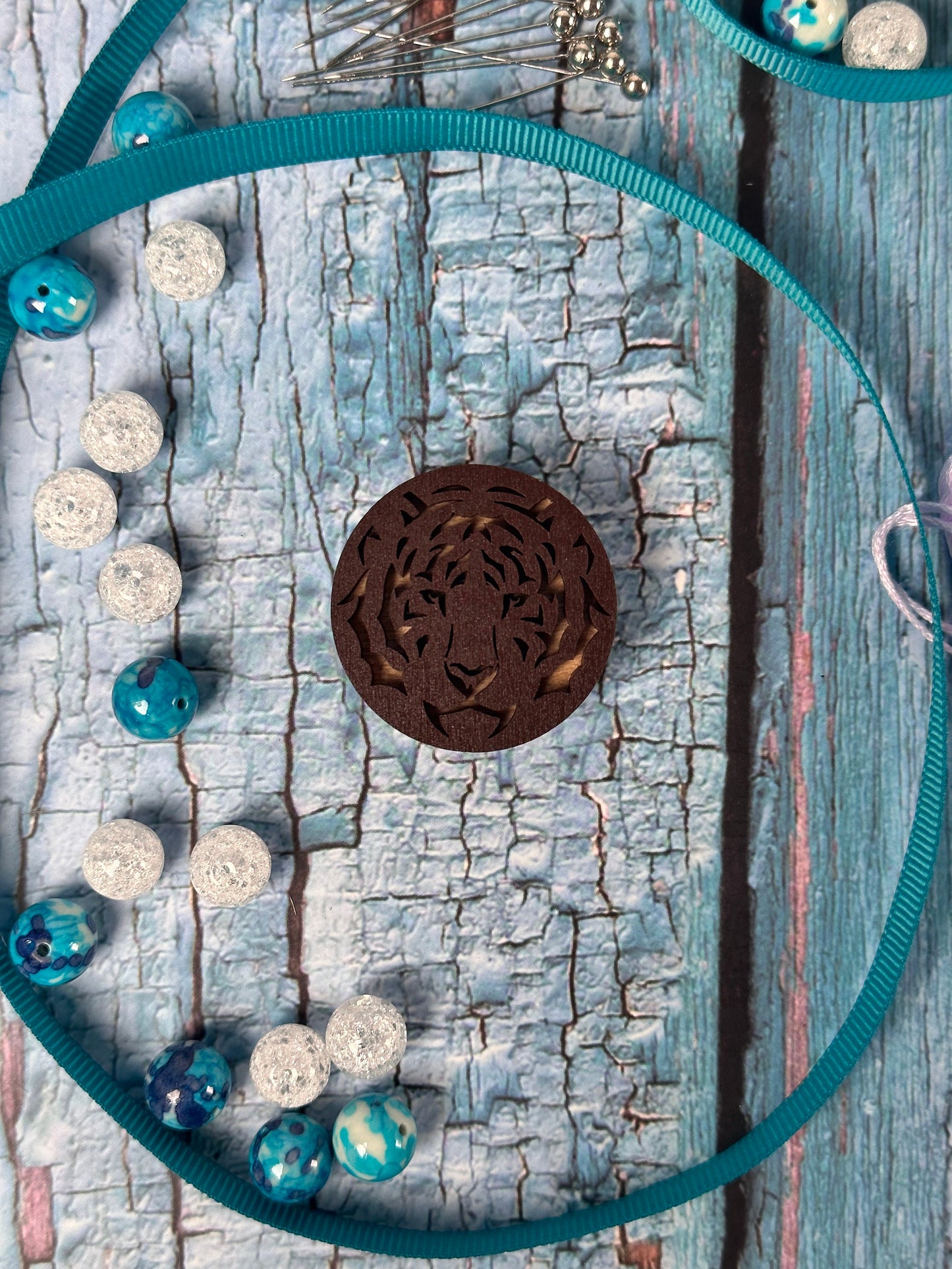 a blue necklace with a brown medallion on it