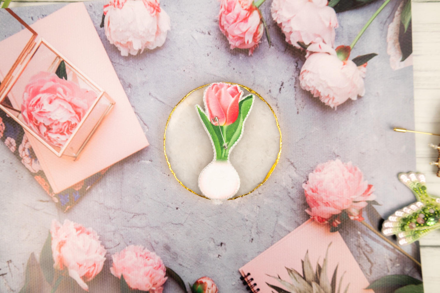 a table topped with pink flowers and pictures