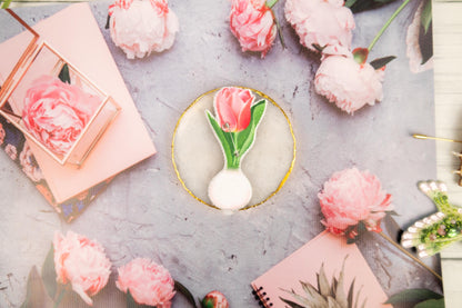 a table topped with pink flowers and pictures