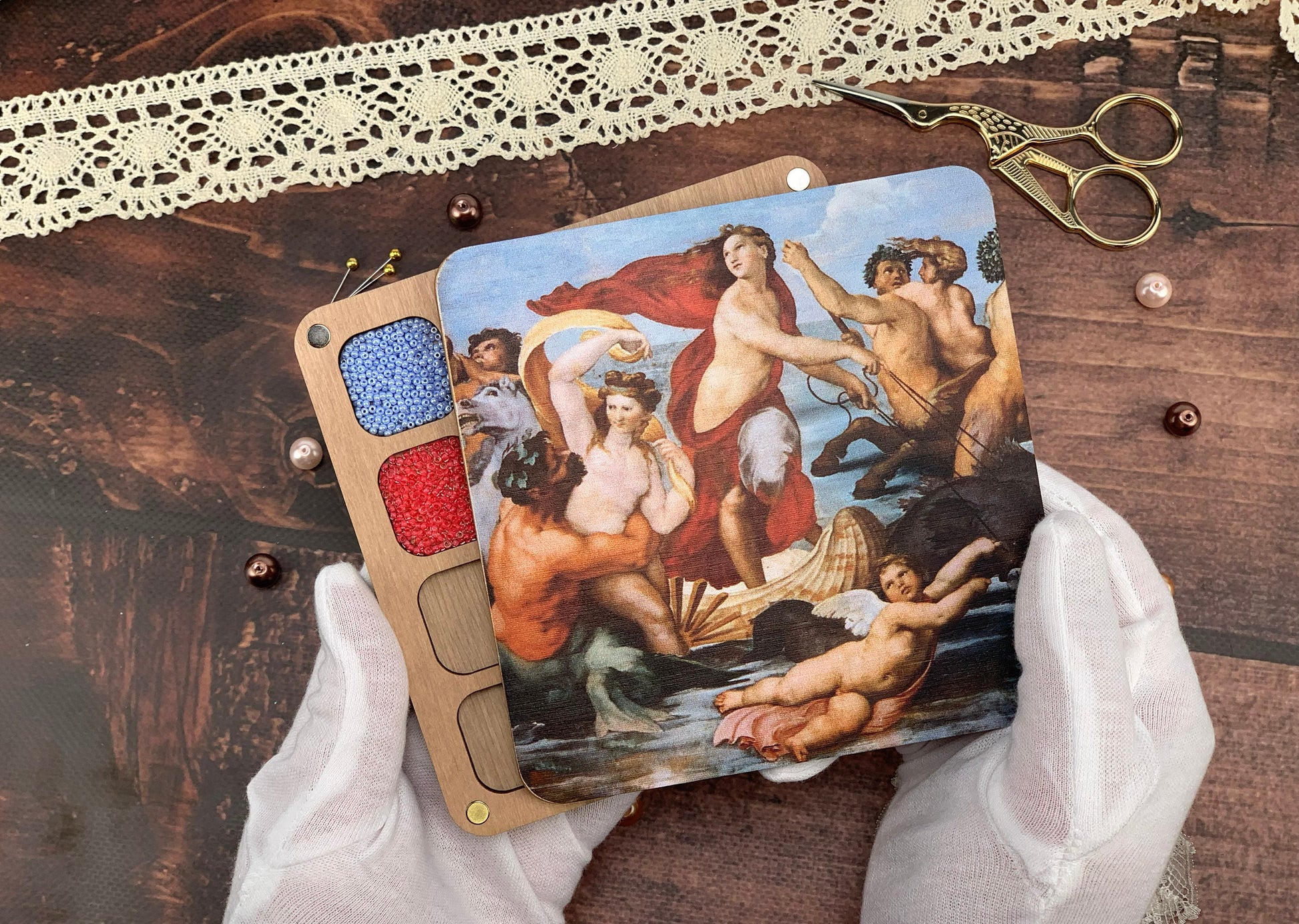 a person holding a piece of art with a painting on it