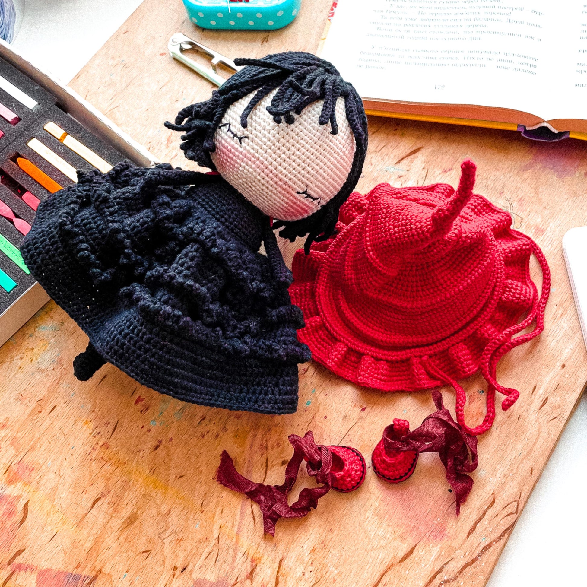 a crocheted doll next to a crocheted hair comb