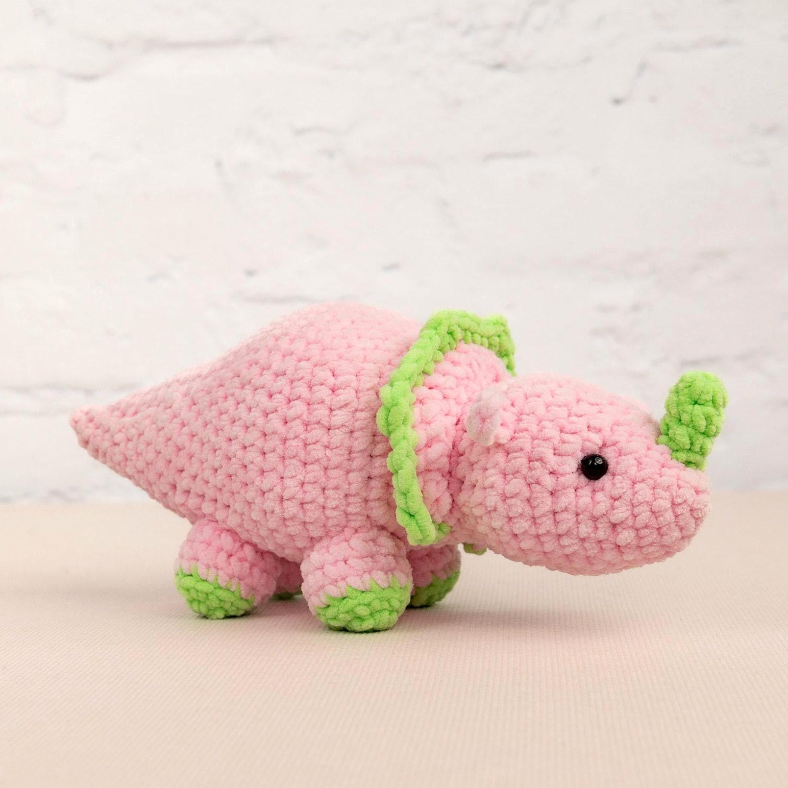 a crocheted pink and green stuffed animal