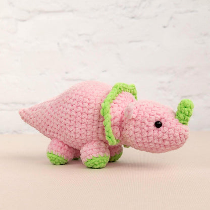 a crocheted pink and green stuffed animal
