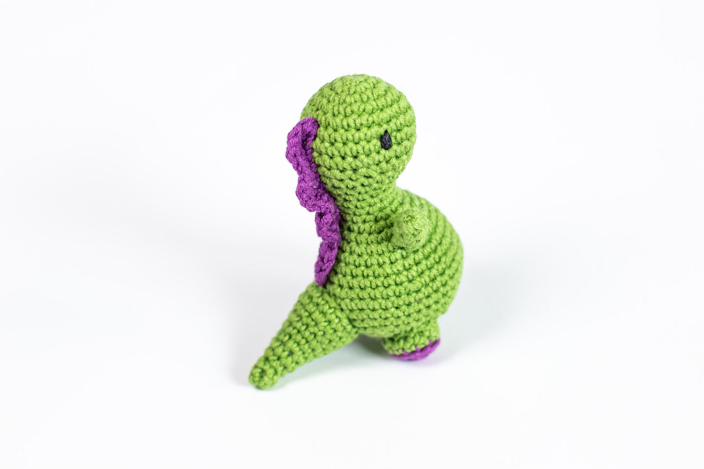 a crocheted green and purple stuffed animal