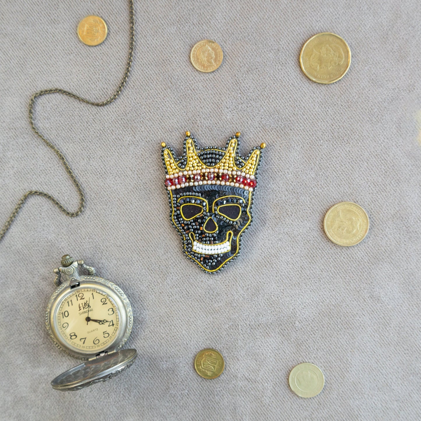 a picture of a clock and a mask on a table