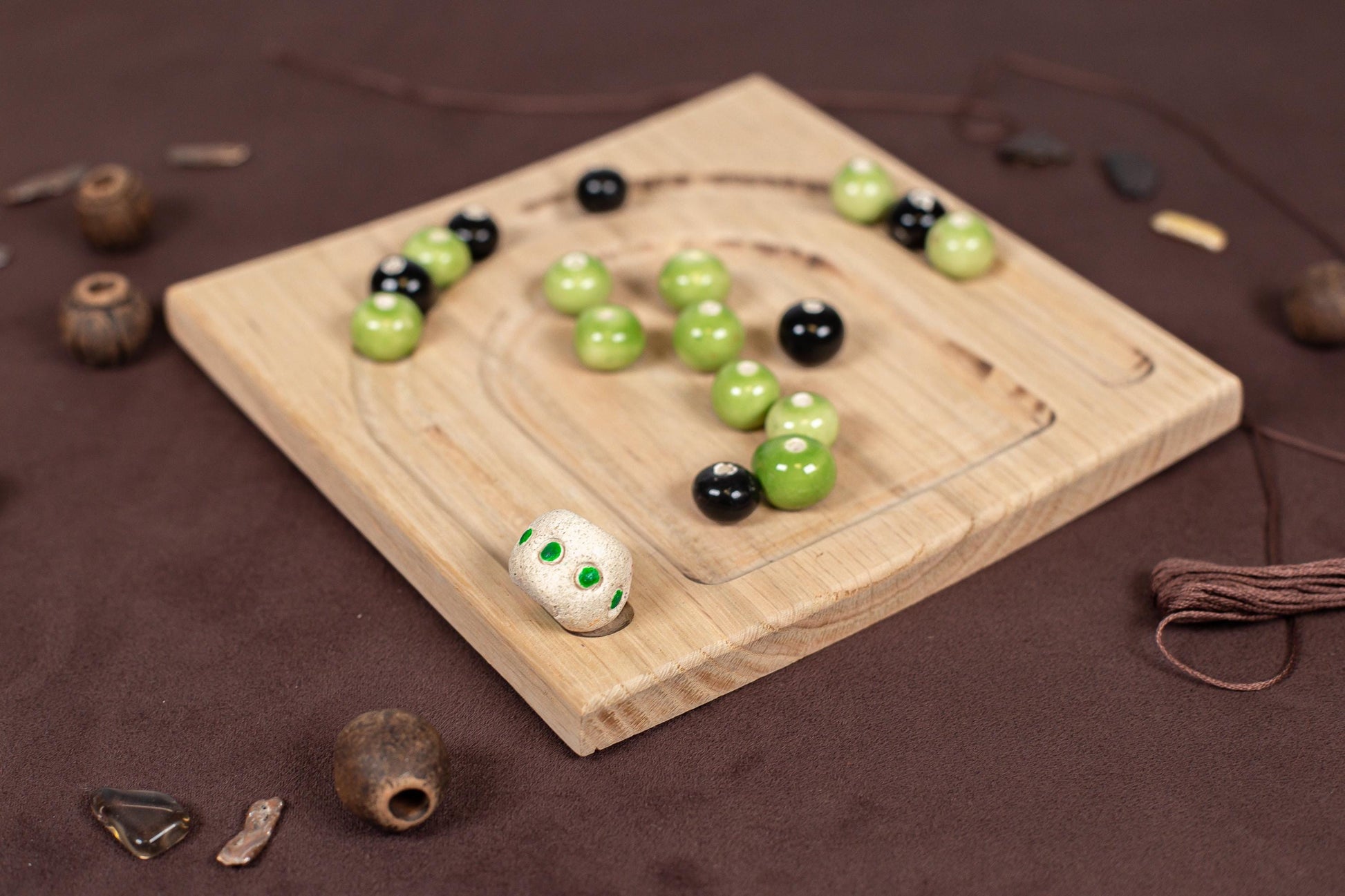 a wooden board topped with green and black balls
