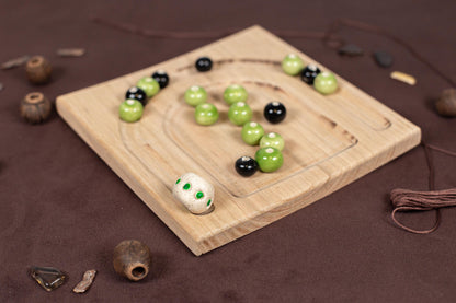 a wooden board topped with green and black balls