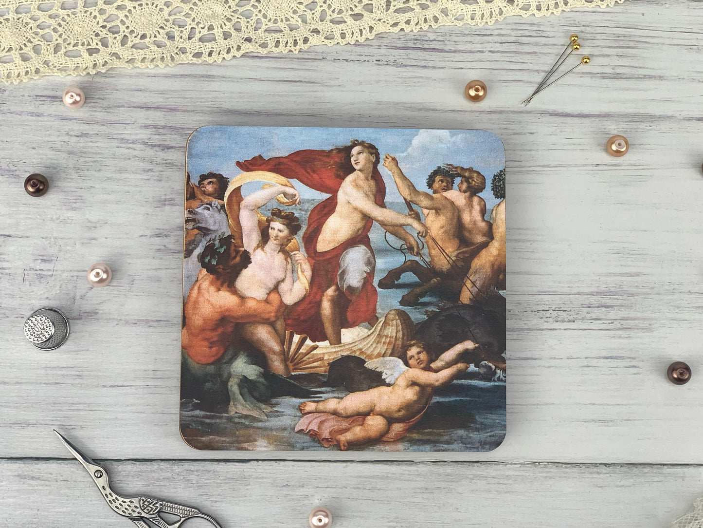 a square coaster with a painting of a woman surrounded by other women