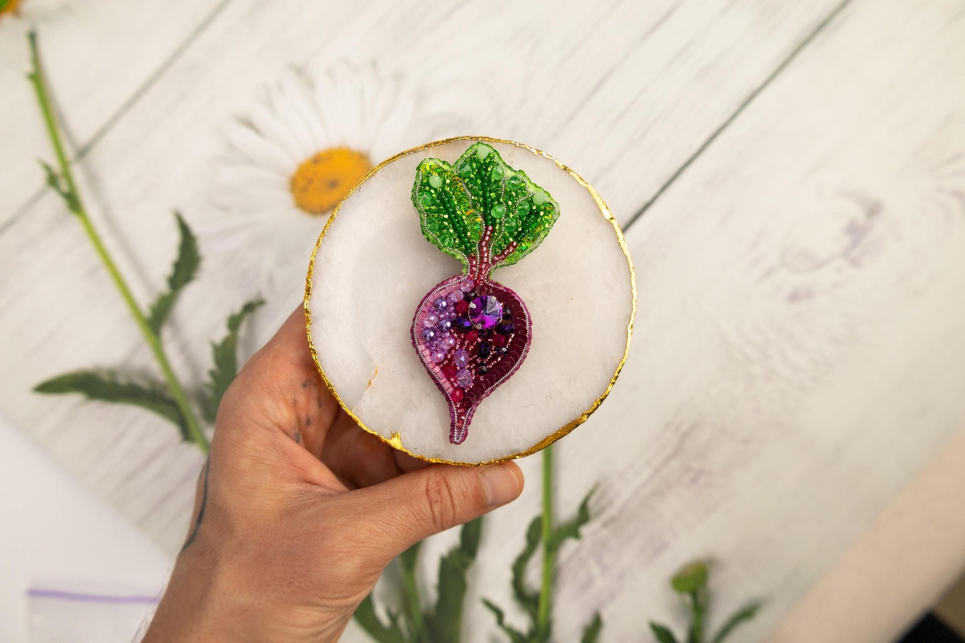 a person holding a small decorative object in their hand