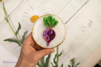 a person holding a small decorative object in their hand