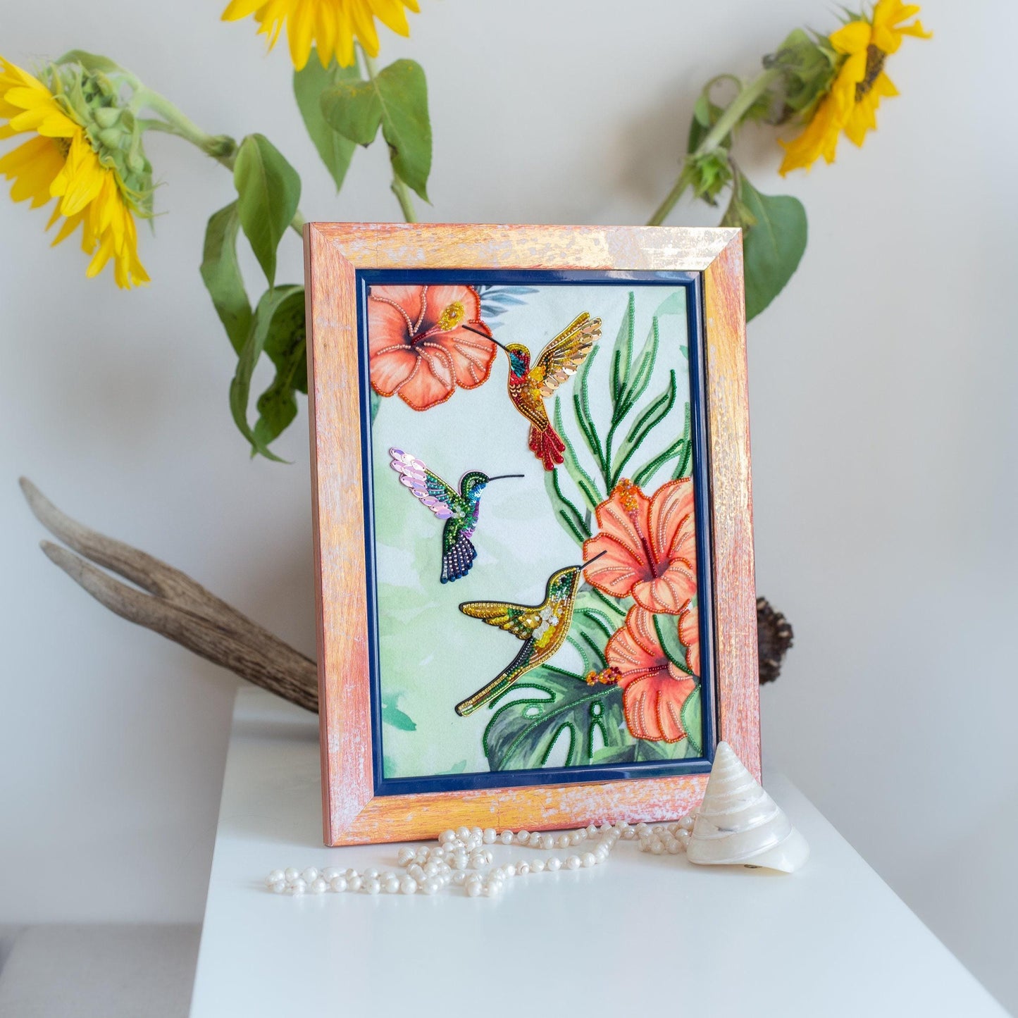 a picture of a hummingbird and flowers on a table